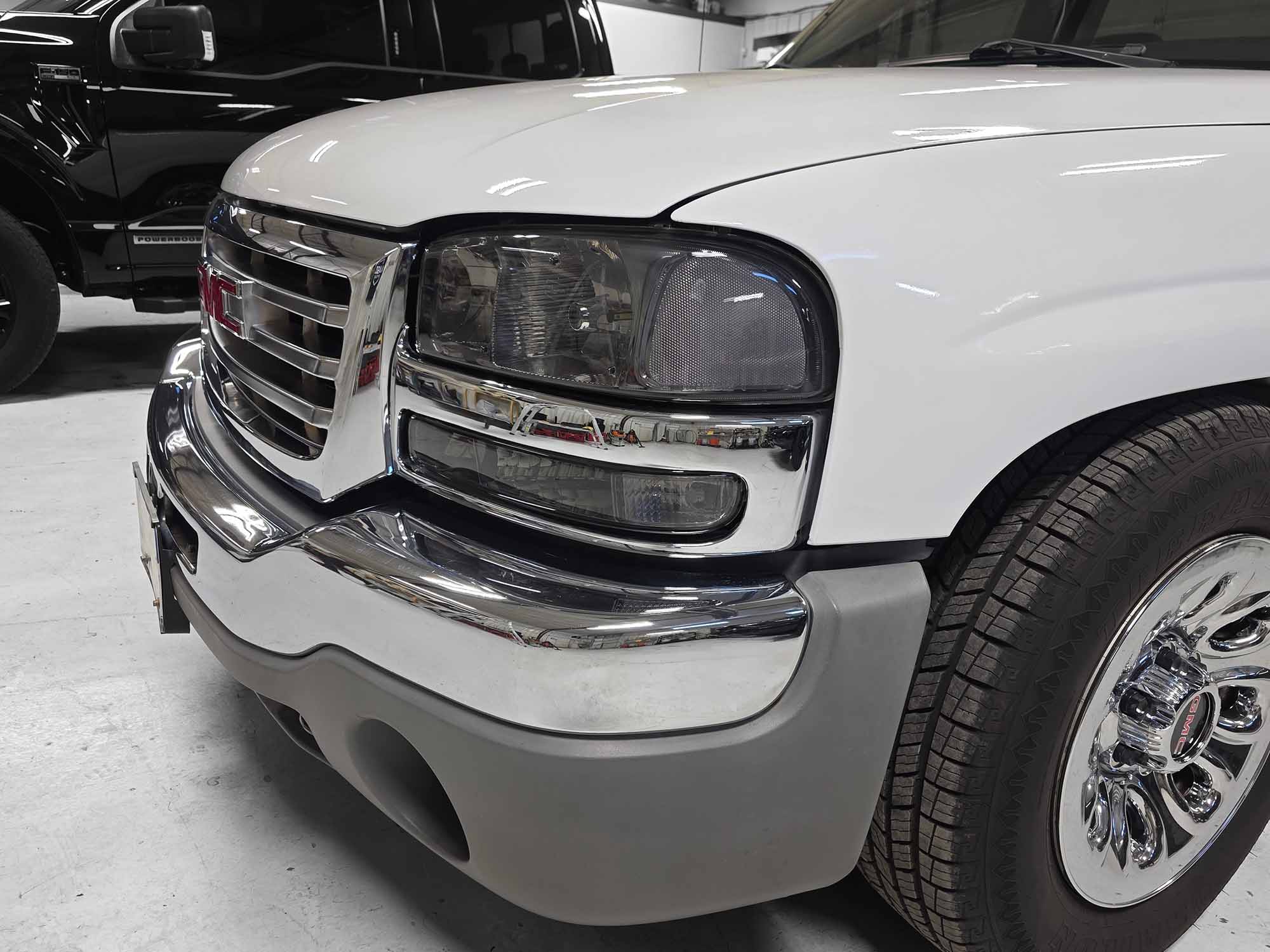 Custom GMC truck featuring smoked headlight assembly installation in Grand Junction