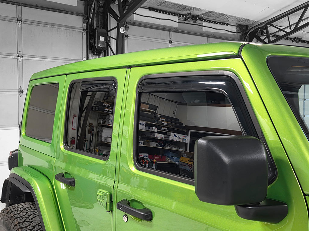 Green Jeep Wrangler with Vent Visors Installed
